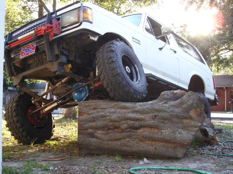 1989 Ford Bronco - This 1989 Ford Bronco is equipped for off-road challenges, resting on a large log.