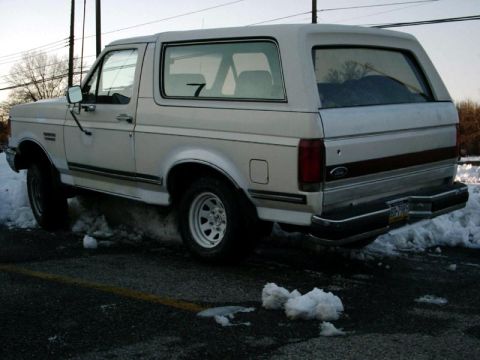 1988 Ford Bronco - Rear view of a 1988 Ford Bronco in a snowy parking lot.