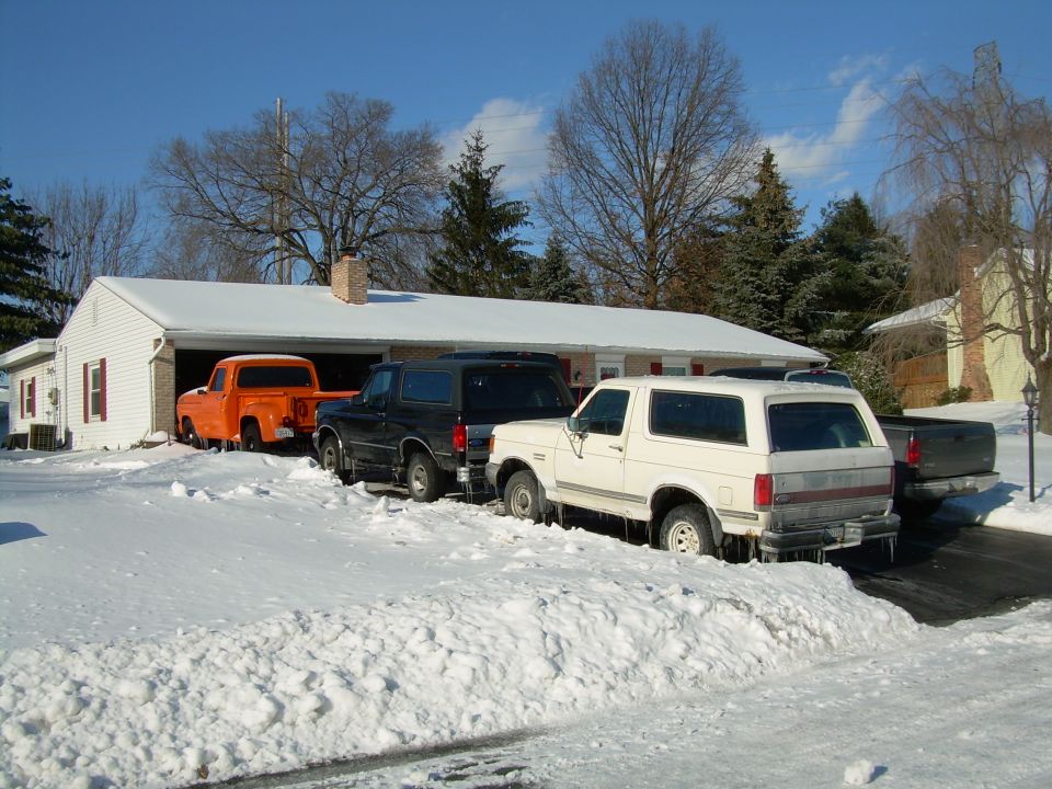 White SUV's rear view in snow, icicles hanging from bumper