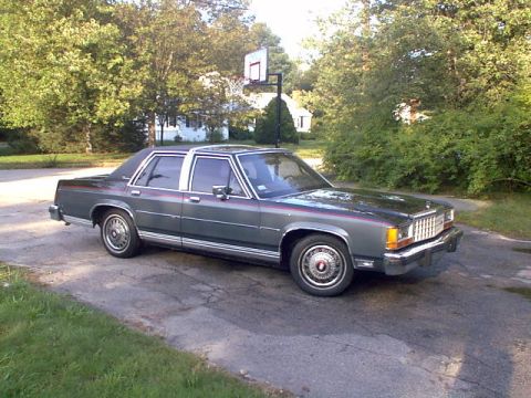 1987 Ford Crown Victoria LTD - This 1987 Ford Crown Victoria LTD is parked on a residential street with a basketball hoop visible.