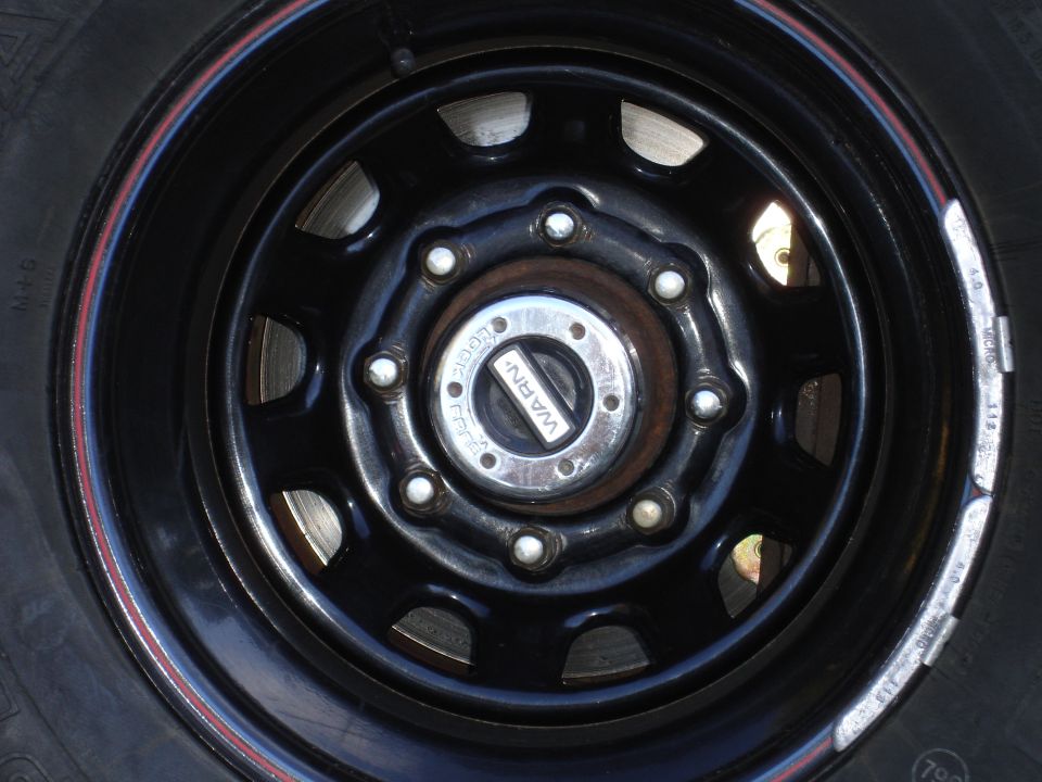 Close-up of a Warn locking hub on a black wheel with red stripe detail
