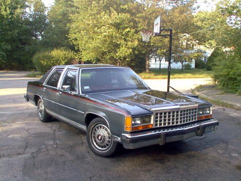 1987 Ford Crown Victoria LTD - 1987 Ford Crown Victoria LTD parked outside on a sunny day with a basketball hoop visible.