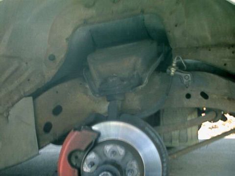 1976 Ford Ranchero - Close-up view of a vehicle's undercarriage, focusing on the brake system and suspension.