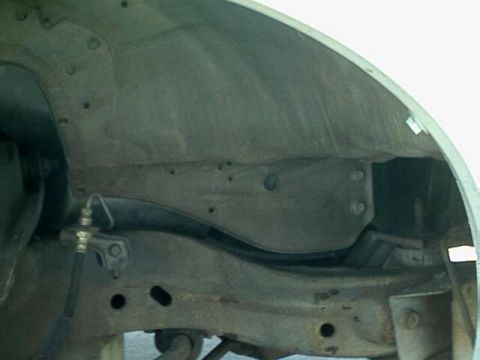 1976 Ford Ranchero - Close-up view of the wheel well and suspension components on a 1976 Ford Ranchero.