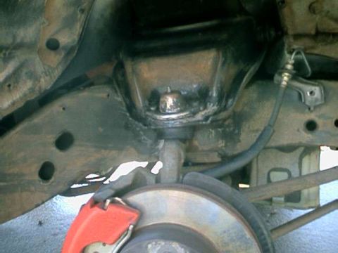 1976 Ford Ranchero - Close-up view of the vehicle's undercarriage, focusing on the brake system and suspension parts.