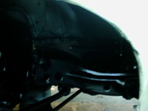 1976 Ford Ranchero - Close-up of a vehicle's undercarriage, focusing on suspension and frame details.