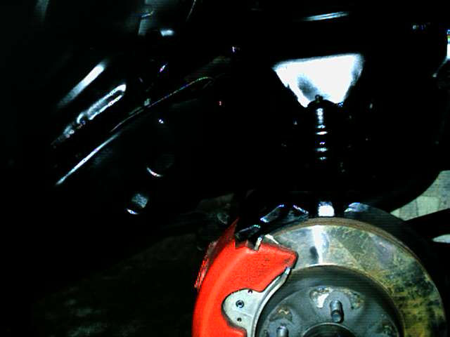 Front brake assembly with red caliper and rotor