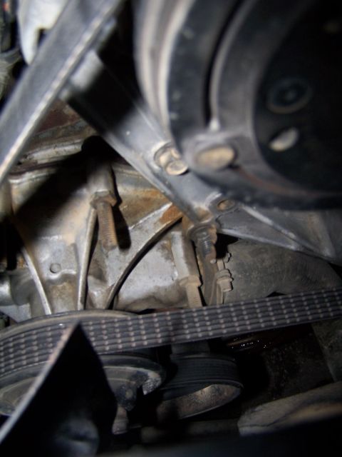 1990 Ford Bronco - Close-up view of engine belts and pulleys.