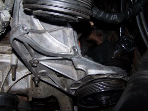 1990 Ford Bronco - Engine bracket assembly with pulleys and associated engine components visible.