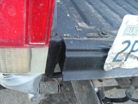 1989 Ford Bronco - The rear of a vehicle is visible, including the taillight, bumper, and a license plate with August visible.