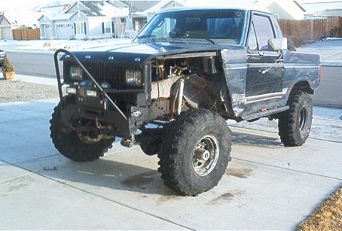 1986 Ford Bronco - This modified Ford Bronco has a custom front end and large off-road tires.