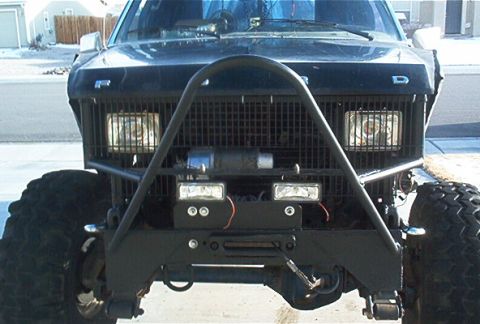 1986 Ford Bronco - This heavily modified Ford Bronco features a custom front end with a winch and auxiliary lighting.