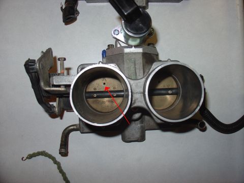 1988 Ford Bronco - This is a close-up view of a vehicle's throttle body assembly, showing two butterfly valves.