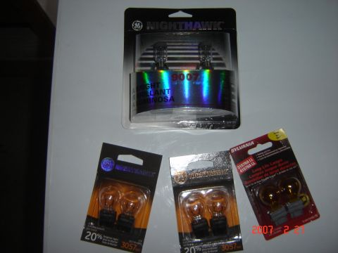 1997 Dodge Grand Caravan - Packaged GE Nighthawk 9007 headlight bulbs and smaller amber signal bulbs from GE and Sylvania are displayed.
