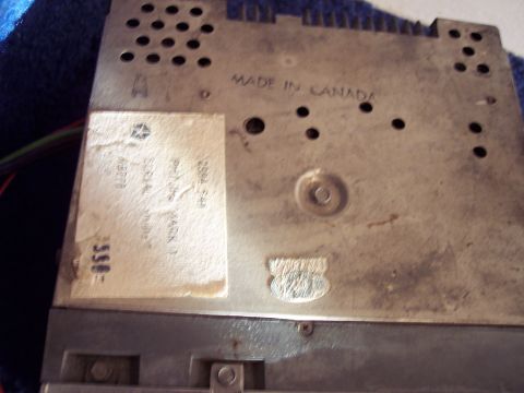 1968 Chrysler Town & Country - Rear view of an AM-FM radio, likely from a Chrysler vehicle, showing manufacturing details and a part number sticker.