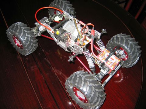 1985 Ford Bronco - This radio-controlled truck chassis features large, knobby tires and visible wiring and suspension components.