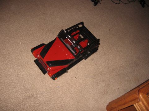 1990 Ford Bronco - A toy Jeep Rubicon with a roll cage sits on a carpeted floor.