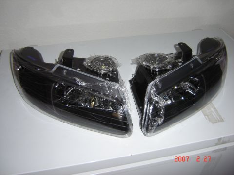 1997 Dodge Grand Caravan - Aftermarket black headlights are shown, still in protective plastic wrap.