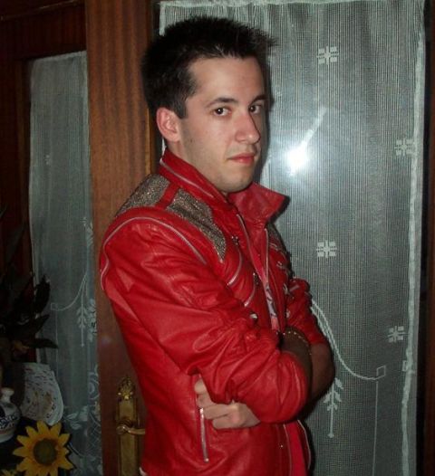 1991 Ford Bronco - A man poses for a photo indoors, wearing a distinctive red jacket with metallic detailing.