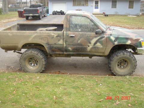 1992 Toyota Tacoma - This 1992 Toyota Tacoma pickup truck features a camouflage paint job and appears to have a lifted suspension.