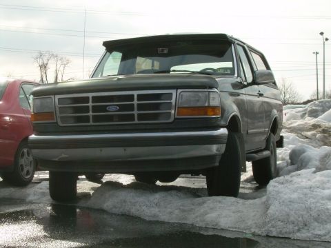 1992 Ford Bronco - This 1992 Ford Bronco is parked in a snowy lot, with its front grille and headlights clearly visible.