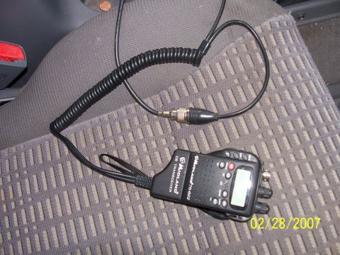 2000 Nissan Xterra - Midland CB radio transceiver with coiled cord on a car seat. Photo dated 02/28/2007.