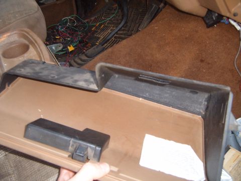 1988 Ford Bronco - The interior of a vehicle with the glove box removed, revealing a mess of wires.