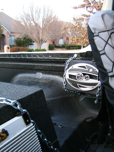 1991 Ford Bronco - Aftermarket audio equipment installed in the bed of a truck, with residential houses visible in the background.