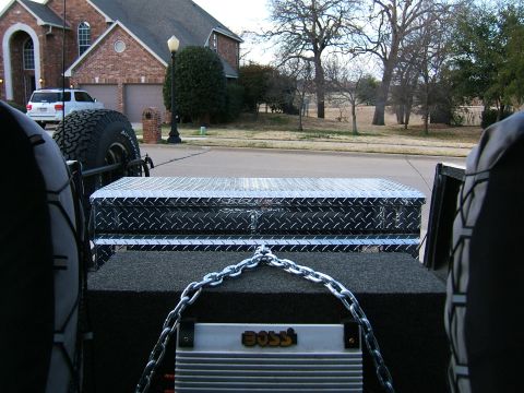 1991 Ford Bronco - View from inside a vehicle shows a toolbox, chain, and BOSS amplifier, with another vehicle visible outside.