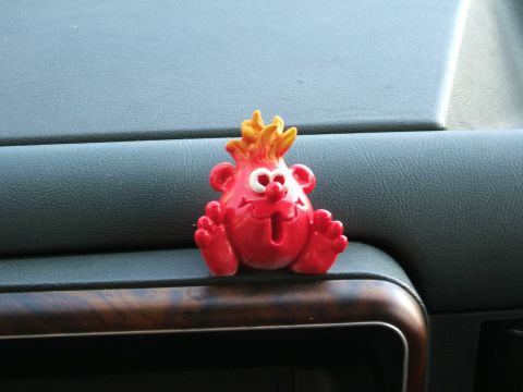 1991 Ford Bronco - Dashboard figurine sits on the dash of a vehicle.