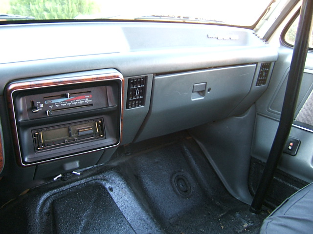 1991 Ford Bronco interior showing the dashboard with radio, air vents, and glove compartment