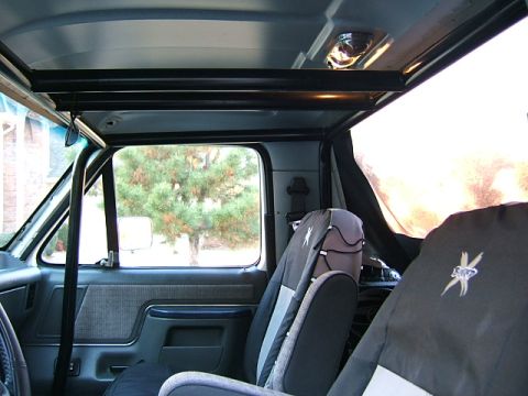 1991 Ford Bronco - Interior view of a 1991 Ford Bronco, equipped with a roll cage and custom seat covers.