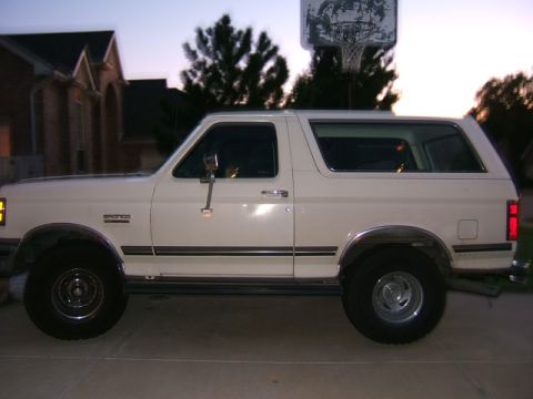 1991 Ford Bronco - A white 1991 Ford Bronco is parked in a driveway at dusk.