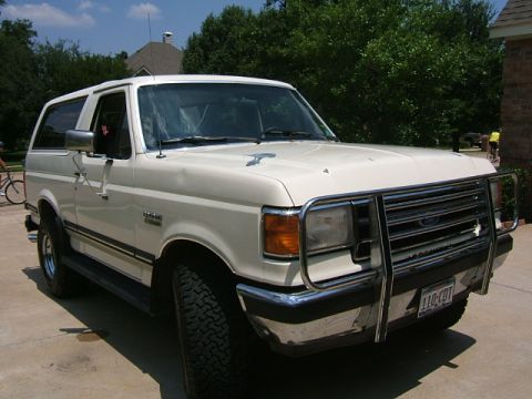 1991 Ford Bronco - This white Ford Bronco features a prominent chrome bull bar and appears to be a 1992 model year.