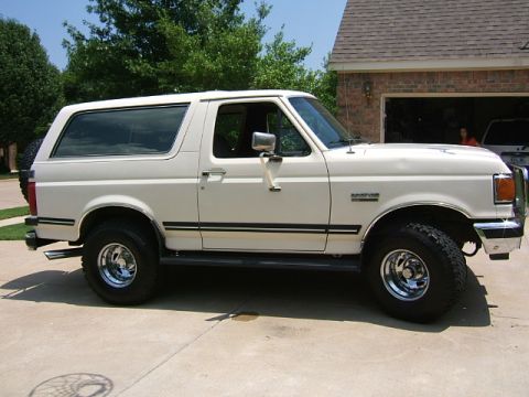 1991 Ford Bronco - This 1991 Ford Bronco is shown from the side, parked in a driveway.