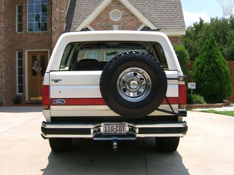 1991 Ford Bronco - Rear view of a 1991 Ford Bronco parked in front of a brick house.