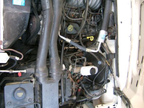 1991 Ford Bronco - Close-up view of a vehicle's engine bay, showing various mechanical parts.