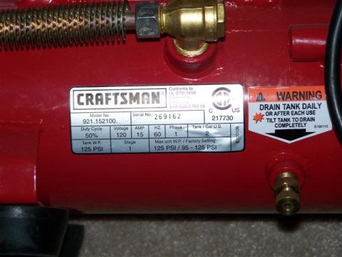 1995 Ford Bronco - Close-up of a red Craftsman air compressor, detailing its specifications and warning labels.
