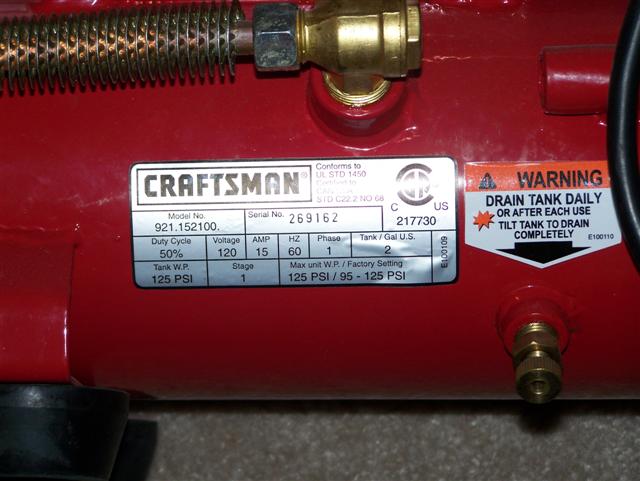 Red Craftsman air compressor with a label showing model number 921.152100 and serial number 269162