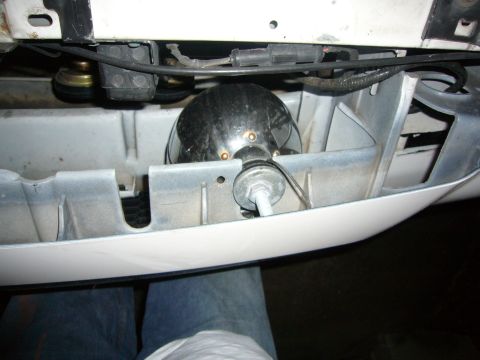 2000 Ford Crown Victoria - Close-up of a chrome fog light assembly, likely an aftermarket addition, mounted behind the front bumper of a vehicle.