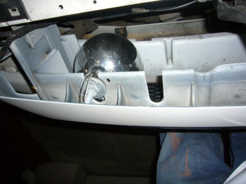 2000 Ford Crown Victoria - Close-up of a chrome fog light assembly installed in a white plastic housing.