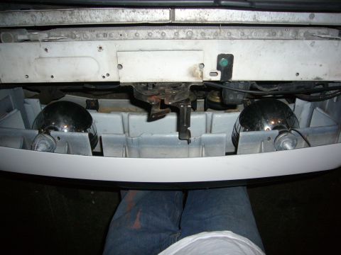 2000 Ford Crown Victoria - Close-up view of the front bumper area, showing fog lights and the hood latch assembly.