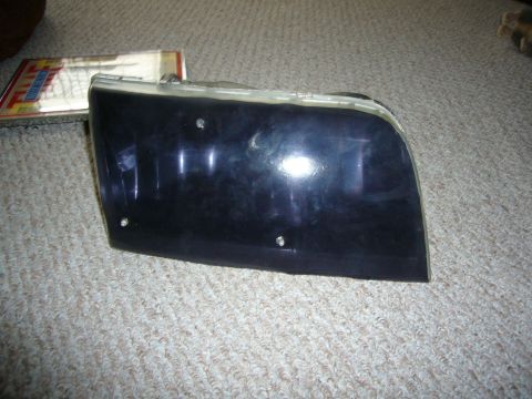 2000 Ford Crown Victoria - A single headlight assembly is shown on a carpeted surface.