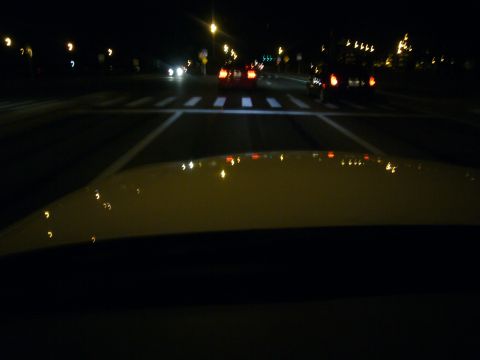 2000 Ford Crown Victoria - Driving at night through a city intersection with a crosswalk and distant traffic.