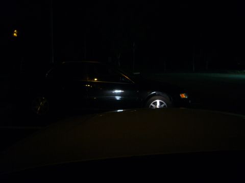 2000 Ford Crown Victoria - A black sedan is parked at night, with its side profile visible.