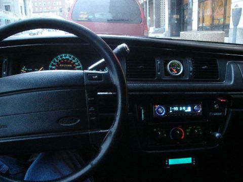1992 Ford Crown Victoria - Interior view of a 1992 Ford Crown Victoria, showing the dashboard, steering wheel, and aftermarket audio system.