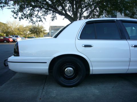 2000 Ford Crown Victoria - Side profile of a white 2000 Ford Crown Victoria, black steel wheels and tinted windows.