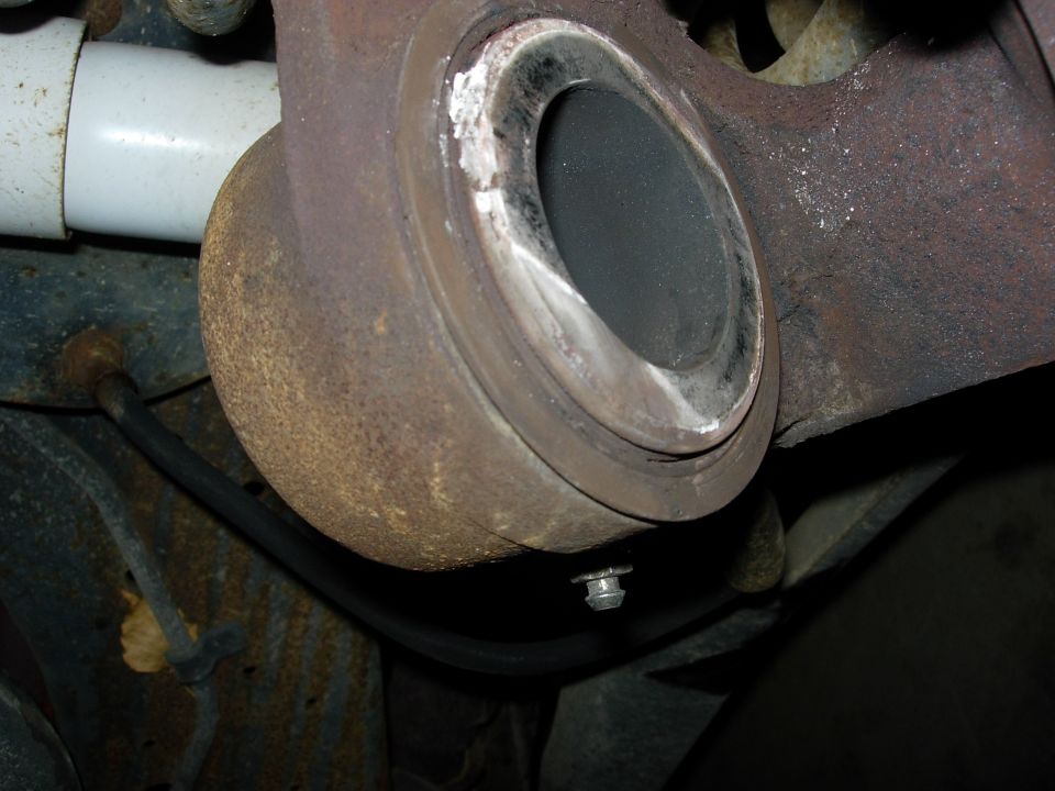 Passenger side caliper.   Seal is flat and hard.  Piston is frozen.