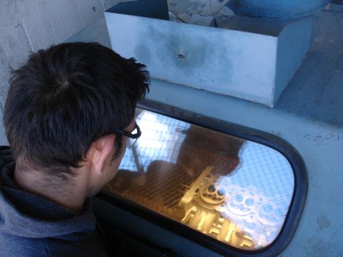 1992 Ford Taurus - A person looks at a golden engine block through a window.