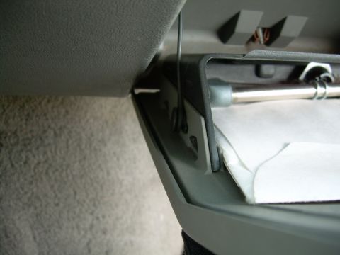 1988 Ford Bronco - Close-up of a car's interior compartment, showing a metal rod and white paper, with a website logo in the corner.